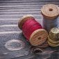 vintage spools thread thimbles wooden board handicraft concept 85x85